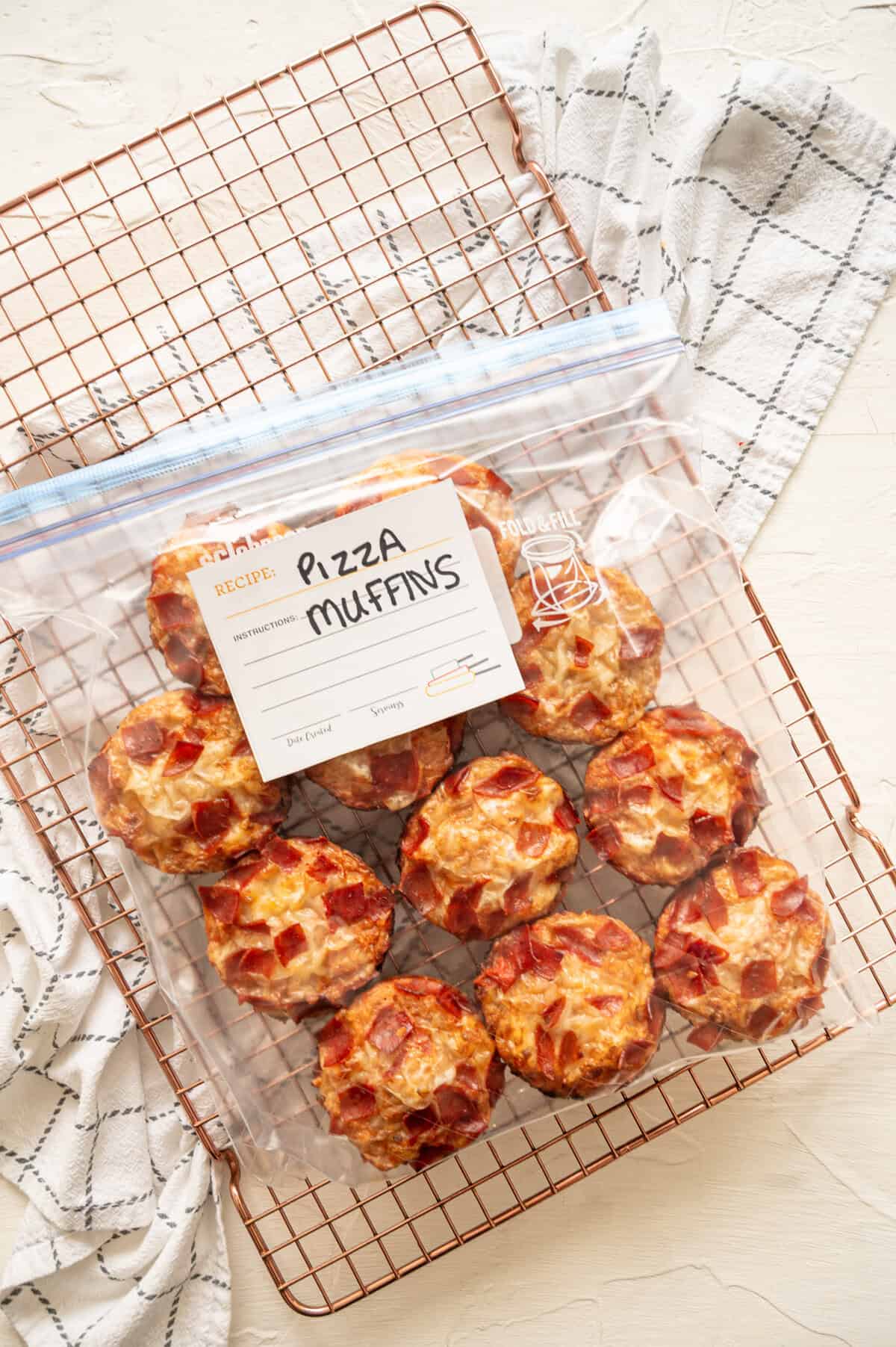 Pepperoni pizza muffins in a gallon-size freezer bag.