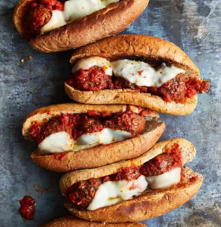 meatball subs lined up on a counter.