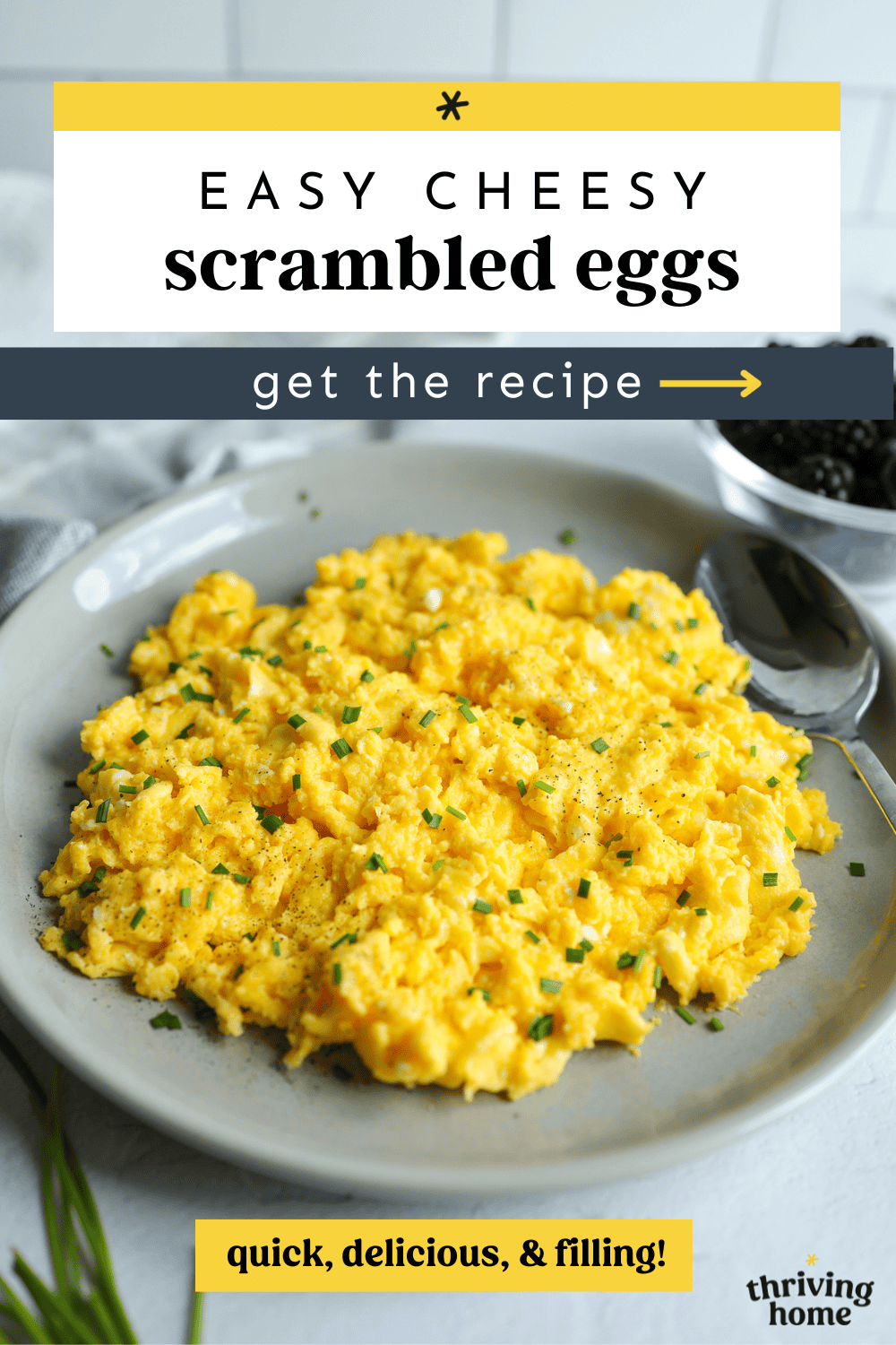 Easy cheesy scrambled eggs in a gray dish with the words, "quick, delicious, & filling" written on the photo.