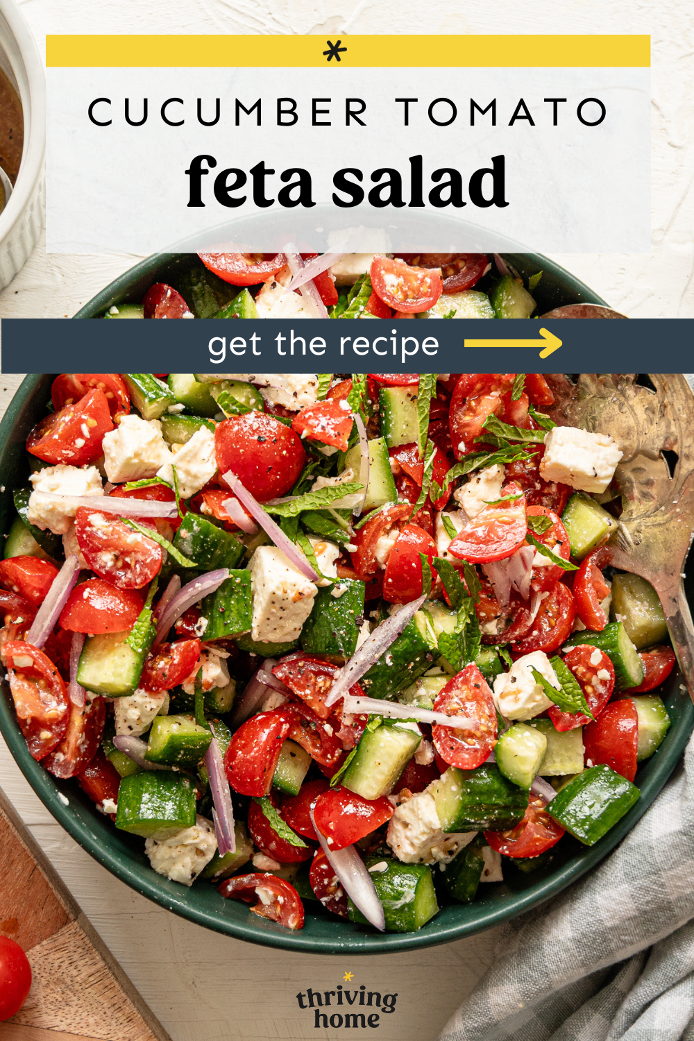 Cucumber tomato feta salad with thinly sliced red onion on top.