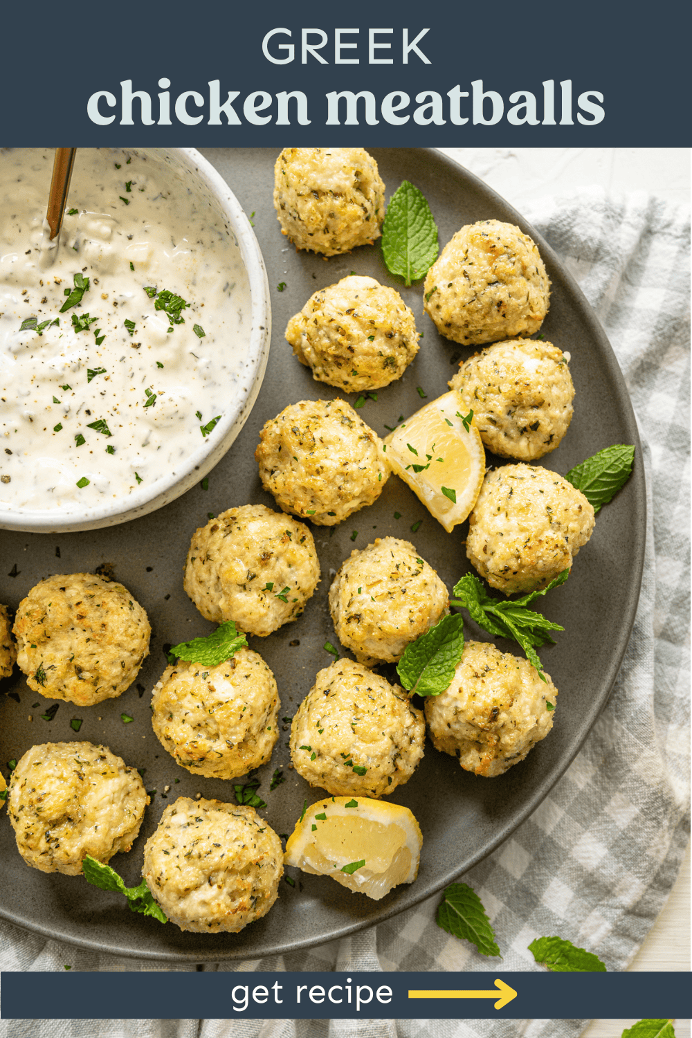 Greek chicken meatballs on a platter with tzatziki sauce for dipping.