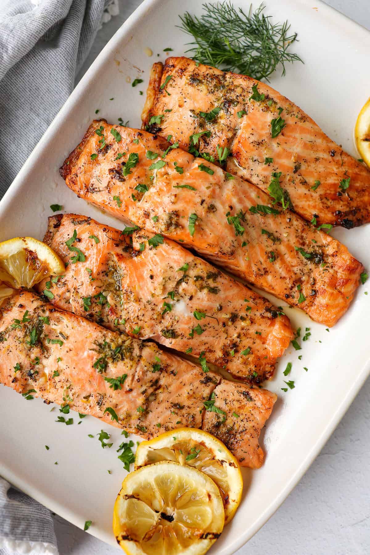 Lemon garlic salmon served on a white platter.