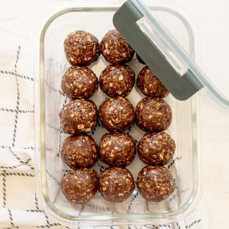 Chocolate Peanut Butter Oatmeal Balls in a glass container ready for the freezer.