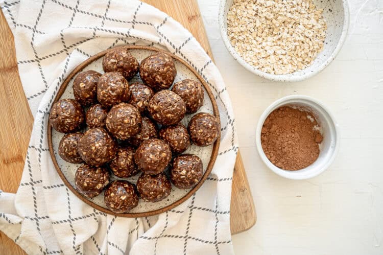 Chocolate peanut butter oatmeal balls stacked up on a plate ready to serve.