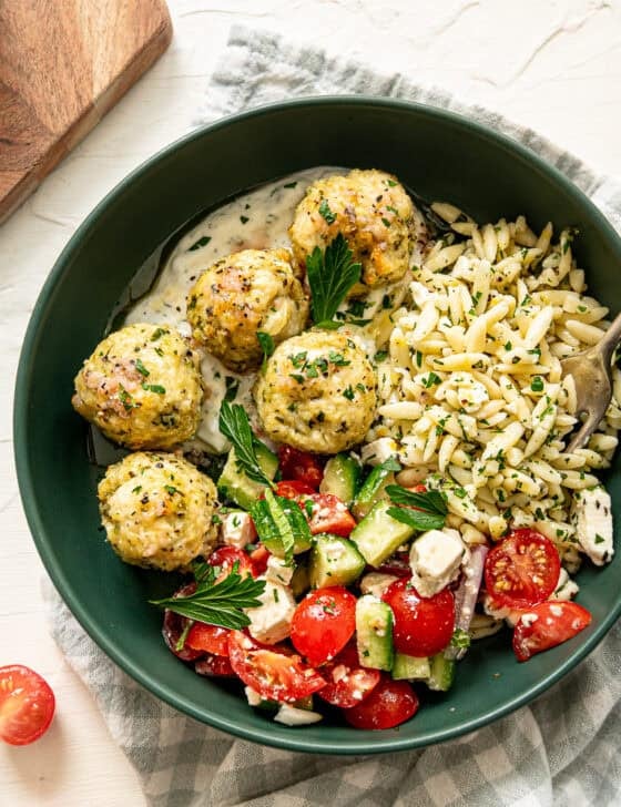 Greek feast with chicken meatballs, tzatziki sauce, cucumber and tomato salad, and lemon feta orzo pasta.