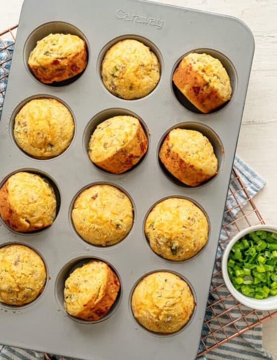 Cornmeal muffins in a muffin pan, fresh from the oven.