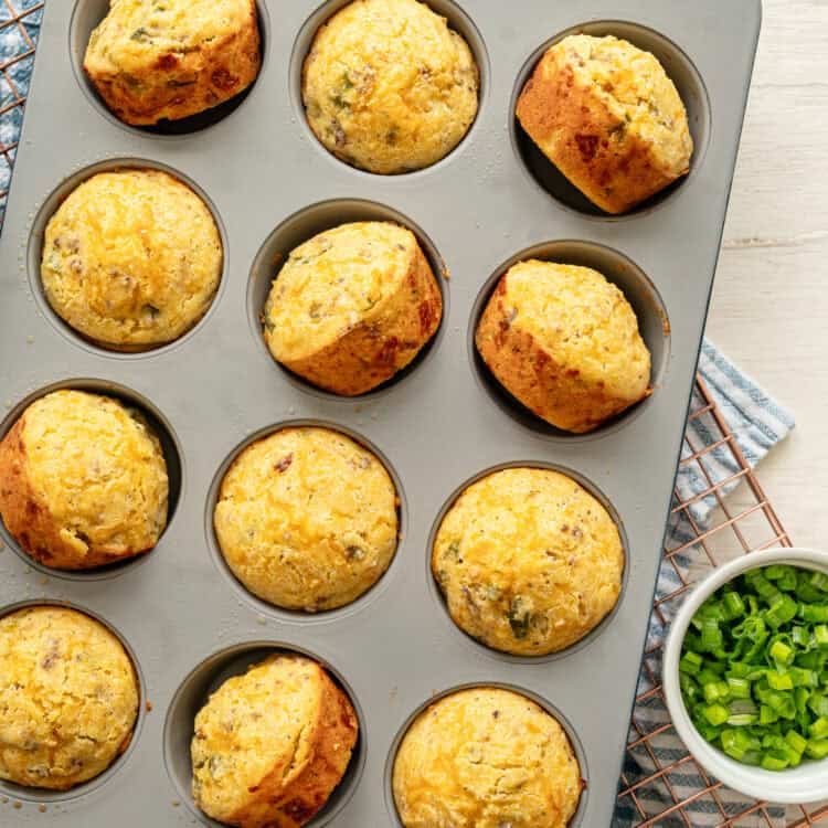 Cornmeal muffins in a muffin pan, fresh from the oven.