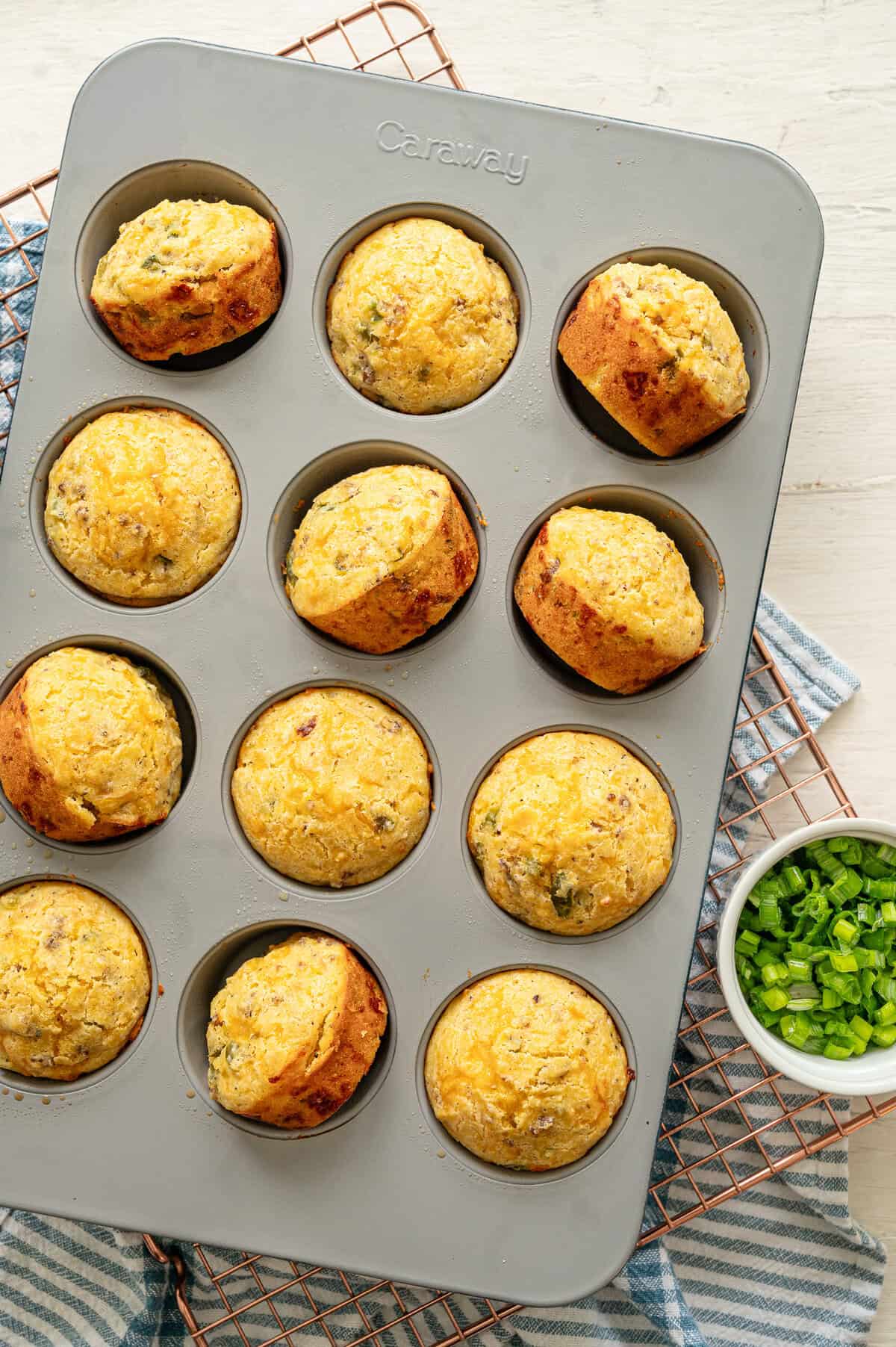 Cornmeal muffins in a muffin pan, fresh from the oven.