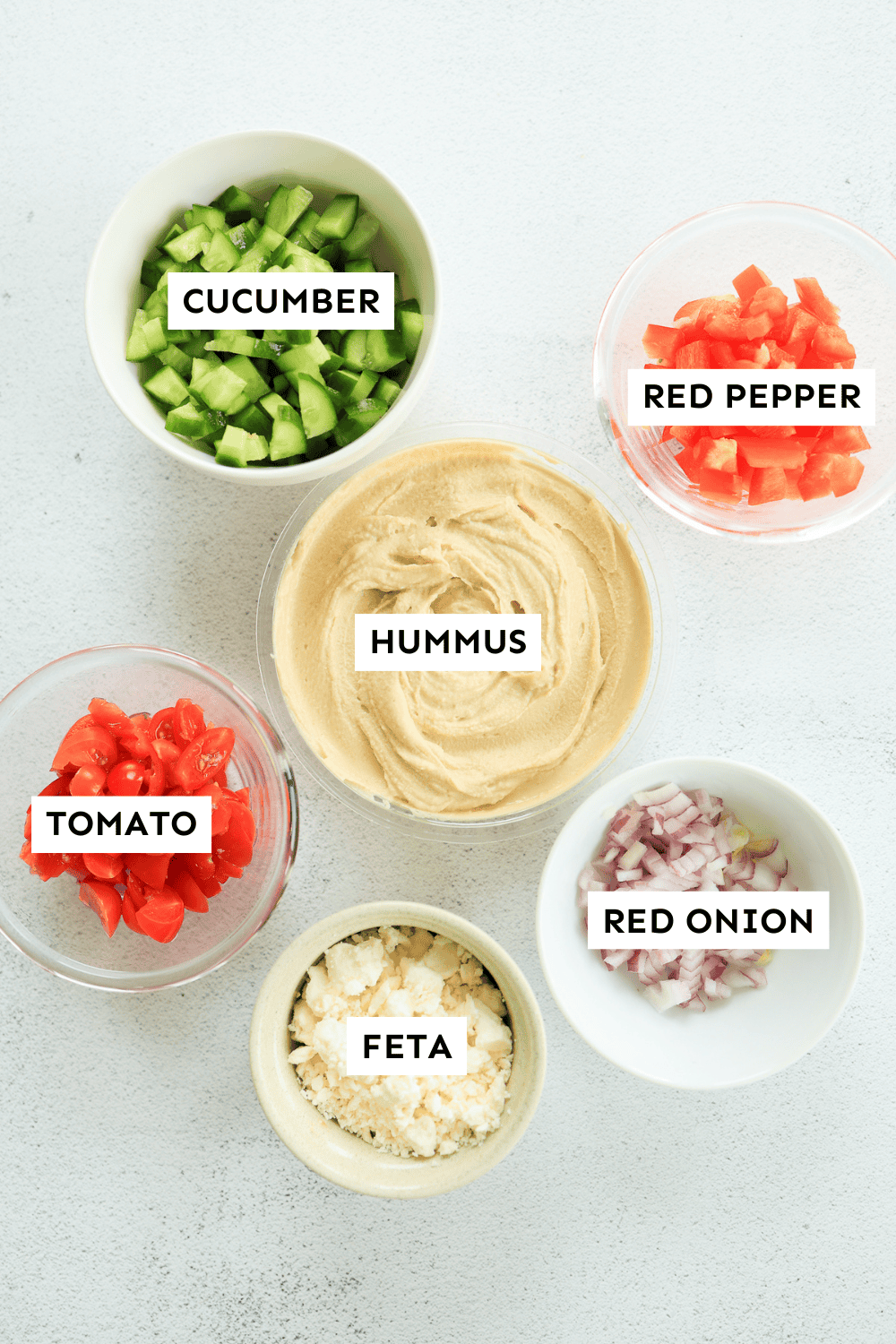 The ingredients for Greek Dip in bowls.