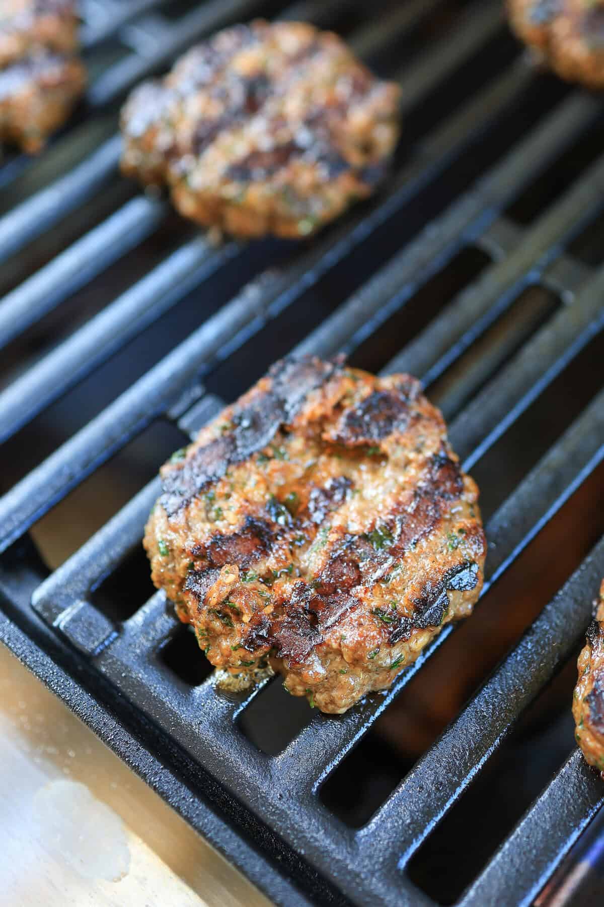 mini burger on a grill with grill marks.