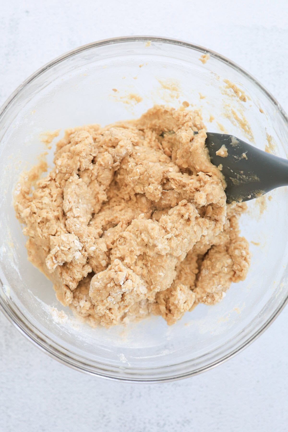 Wet ingredients for oatmeal muffins being mixed into the dry ingredients.
