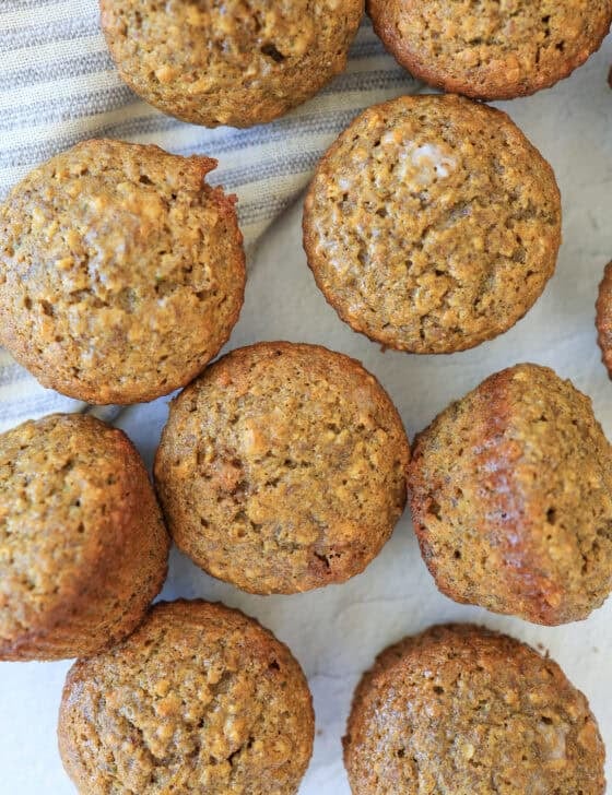 A bunch of muffins on a white table.