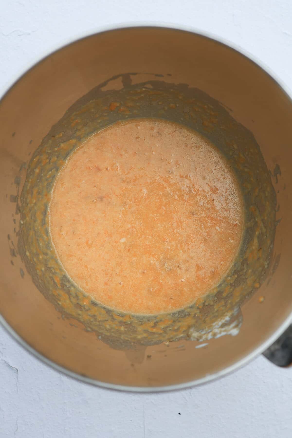 Wet ingredients for a sweet bread in a metal mixing bowl.