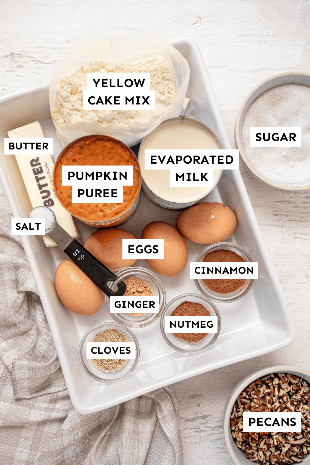 Pumpkin dump cake ingredients measured out and labeled.