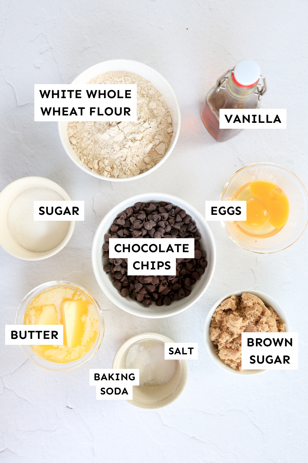 Whole wheat chocolate chip cookie ingredients measured out and labeled.
