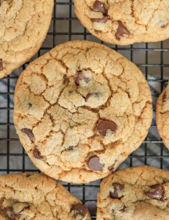 Whole wheat chocolate chip cookies cooling on a baking rack.