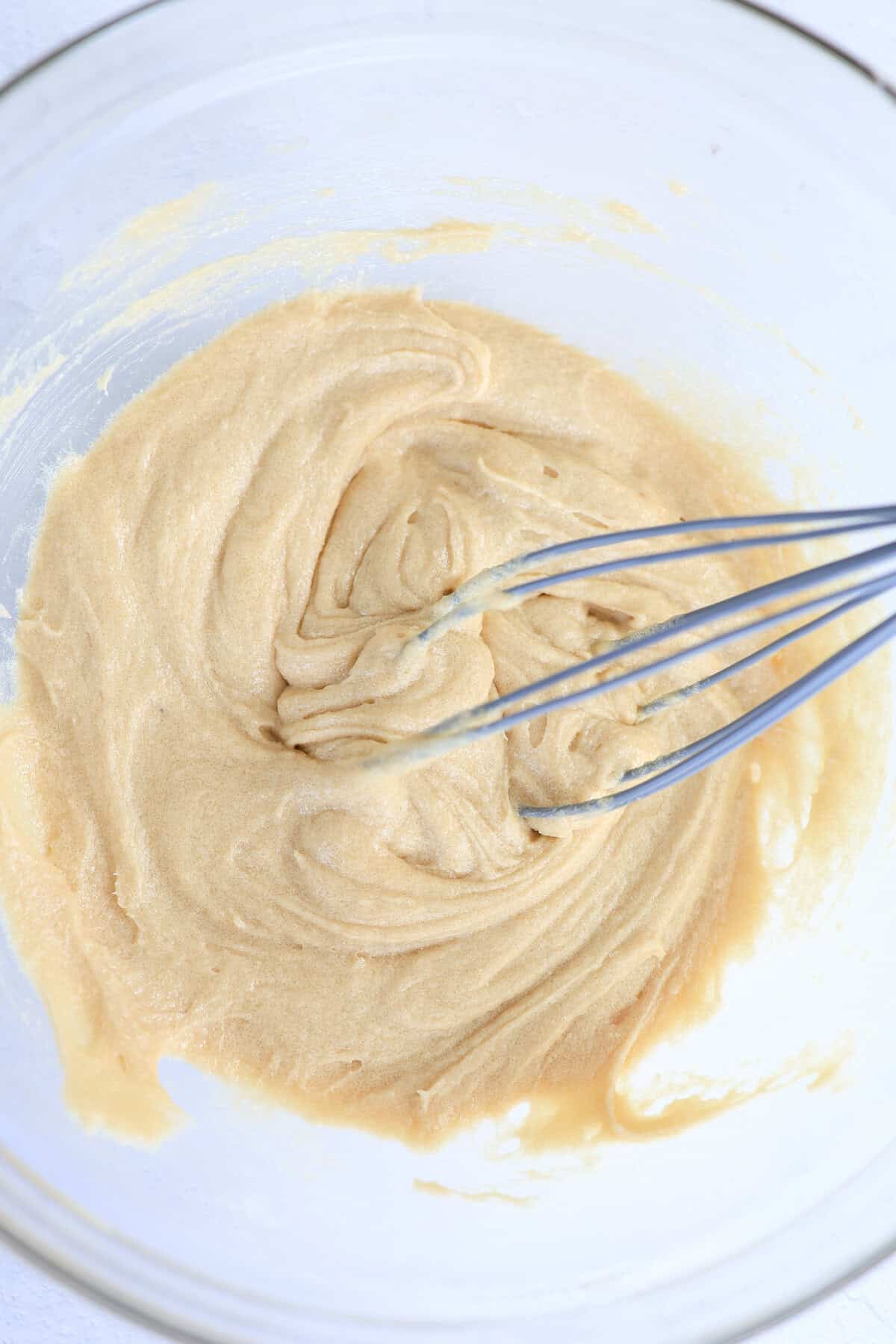 Cookie dough being mixed with a whisk.