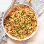 Egg fried rice in a ceramic skillet.