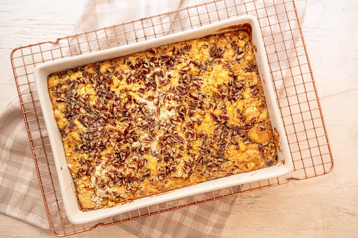 Pumpkin dump cake straight from the oven cooling on a rack.