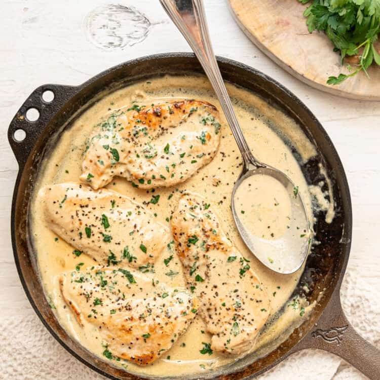Boursin chicken ready to serve from a cast iron skillet.