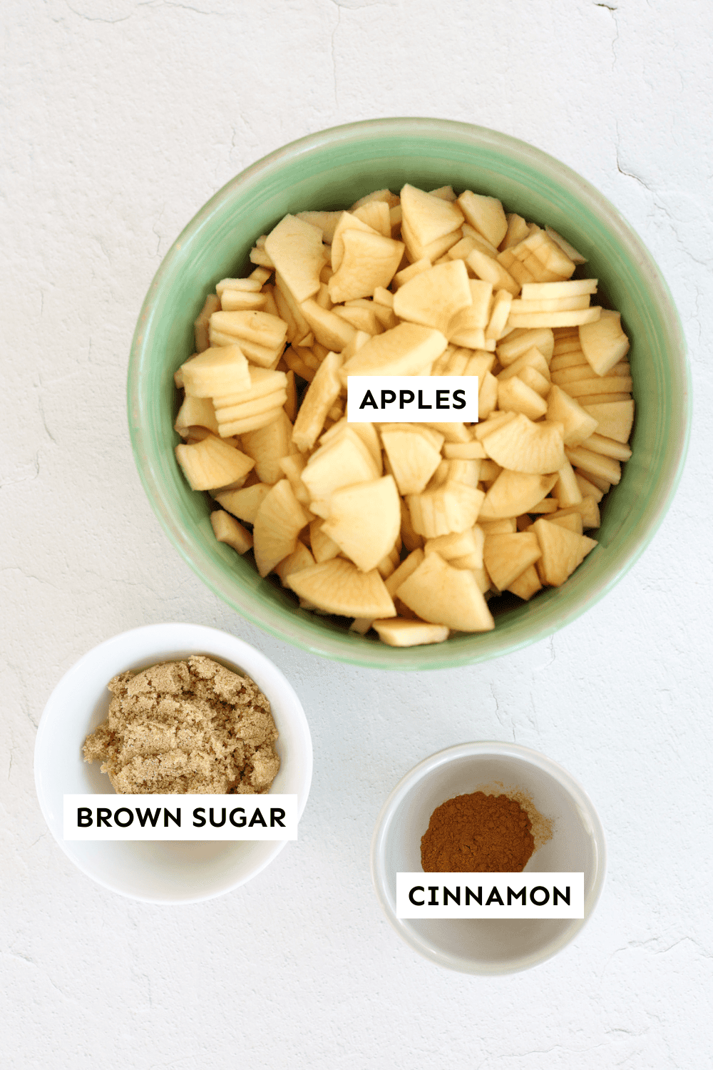 Ingredients for crockpot applesauce measured out and labeled.