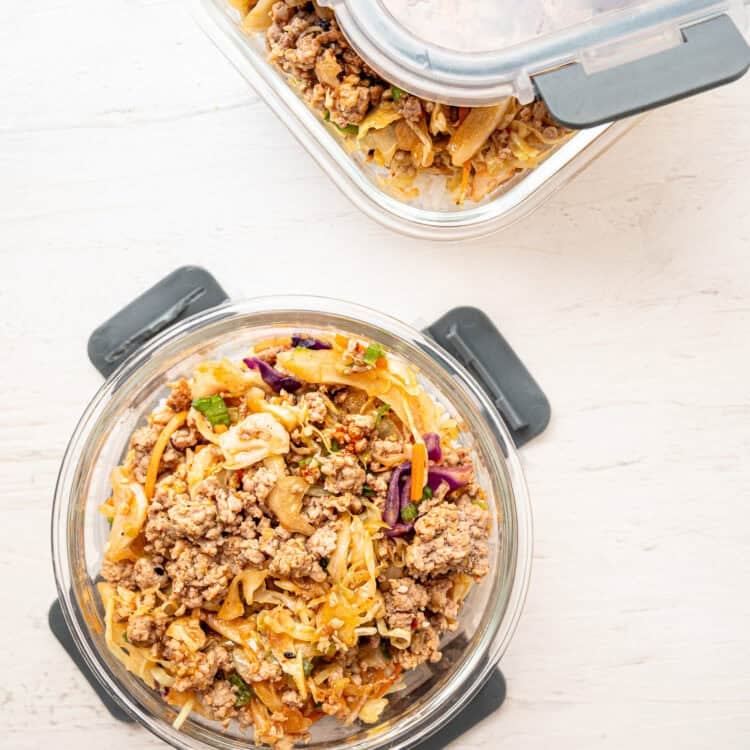 Cooked egg roll ingredients in a glass dish with lid.