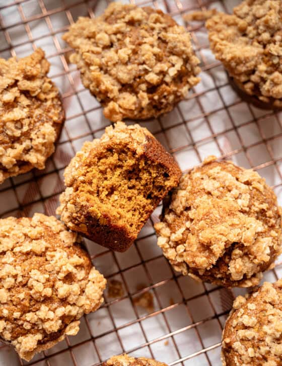 Pumpkin spice muffins with crumble topping on a cooling rack.