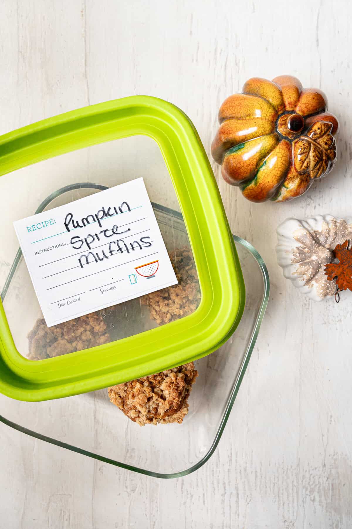 Muffins in a glass dish labeled pumpkin spice muffins on top.