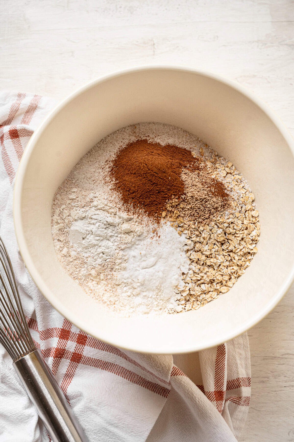 Dry ingredients for pumpkin spice muffins in a bowl.