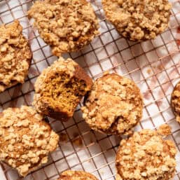 Pumpkin spice muffins on a cooling rack.