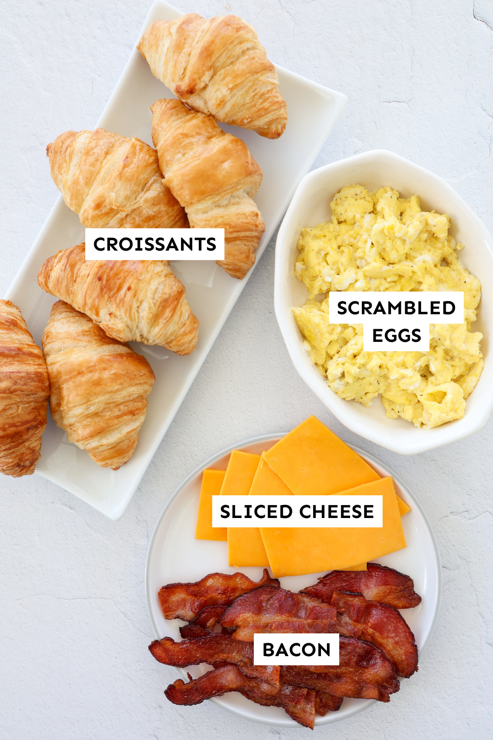 Ingredients for croissant breakfast sandwiches laid out and labeled.
