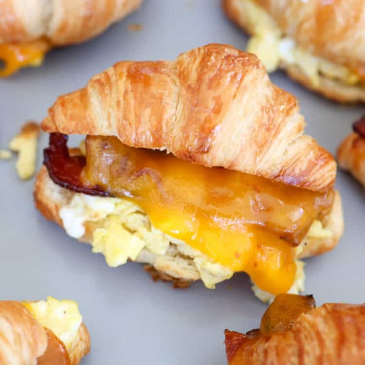 A baking sheet straight from the oven with croissant breakfast sandwiches.