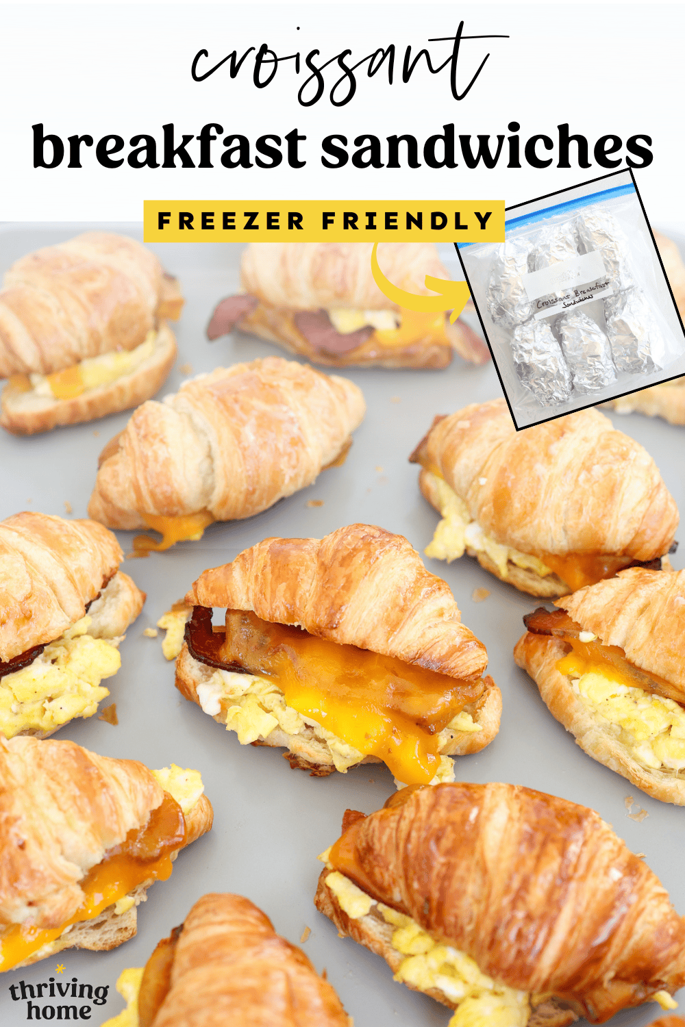 Croissant breakfast sandwiches on a baking sheet with an inset photo of foil-wrapped sandwiches in a freezer bag.
