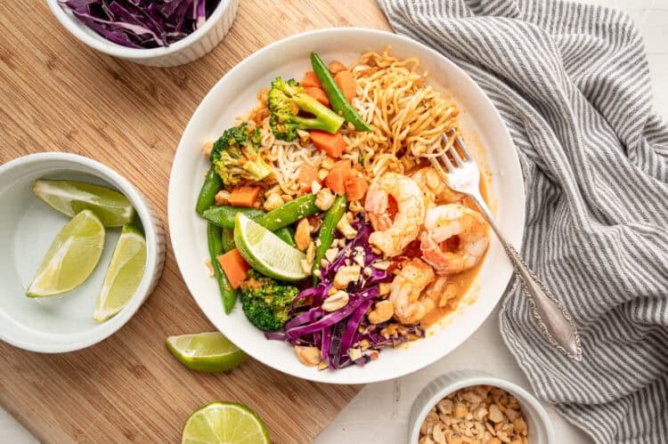 A shrimp curry bowl with chopped peanuts on top.