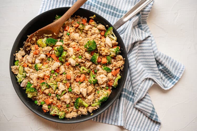 A skillet of chicken fried rice on the counter.