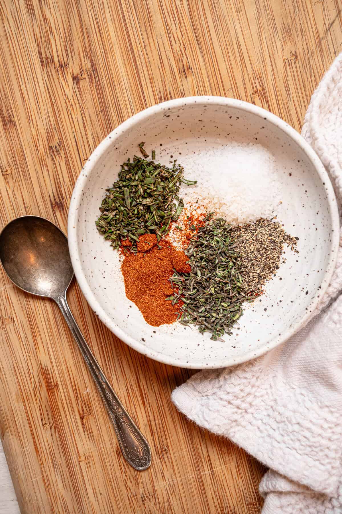 Dried seasonings piled separately in a shallow bowl before being mixed together.