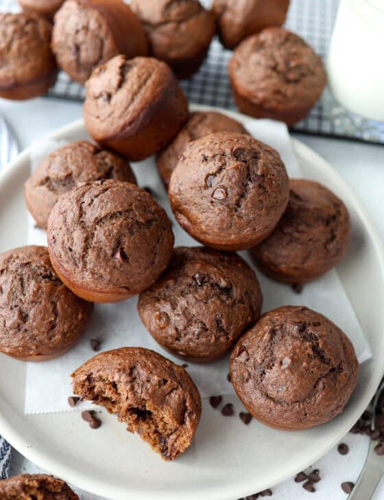 Chocolate banana muffins piled on a plate.