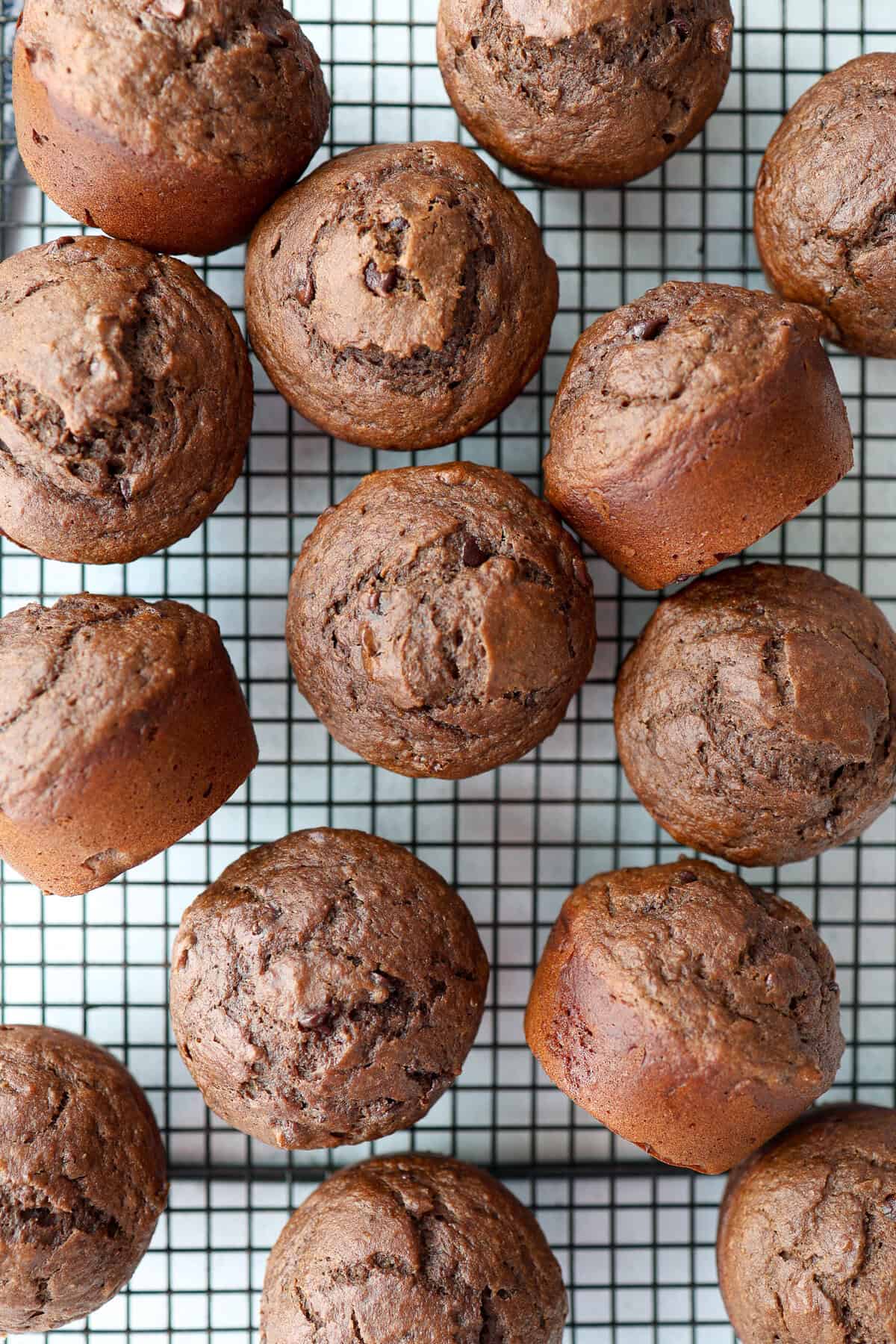 Chocolate banana muffins on a cooling rack.