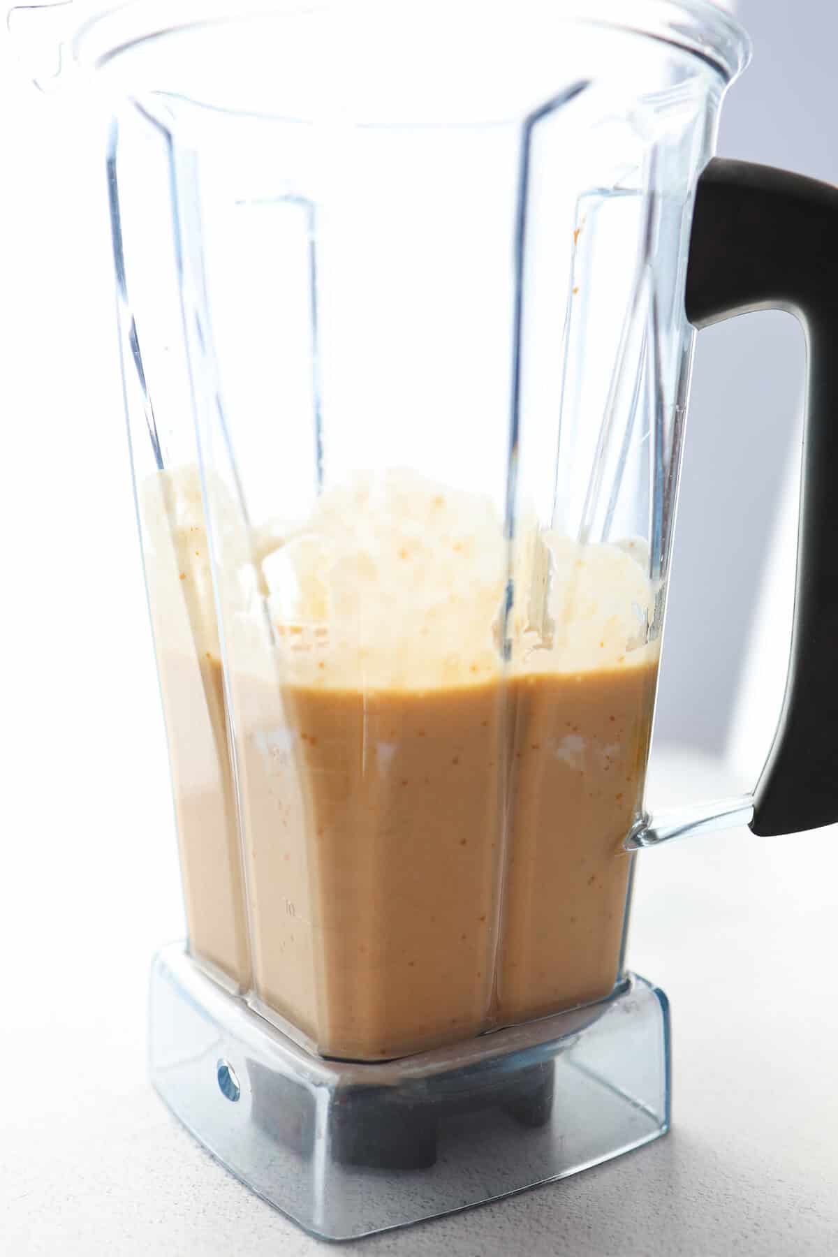 Wet ingredients in a blender for chocolate banana muffins.
