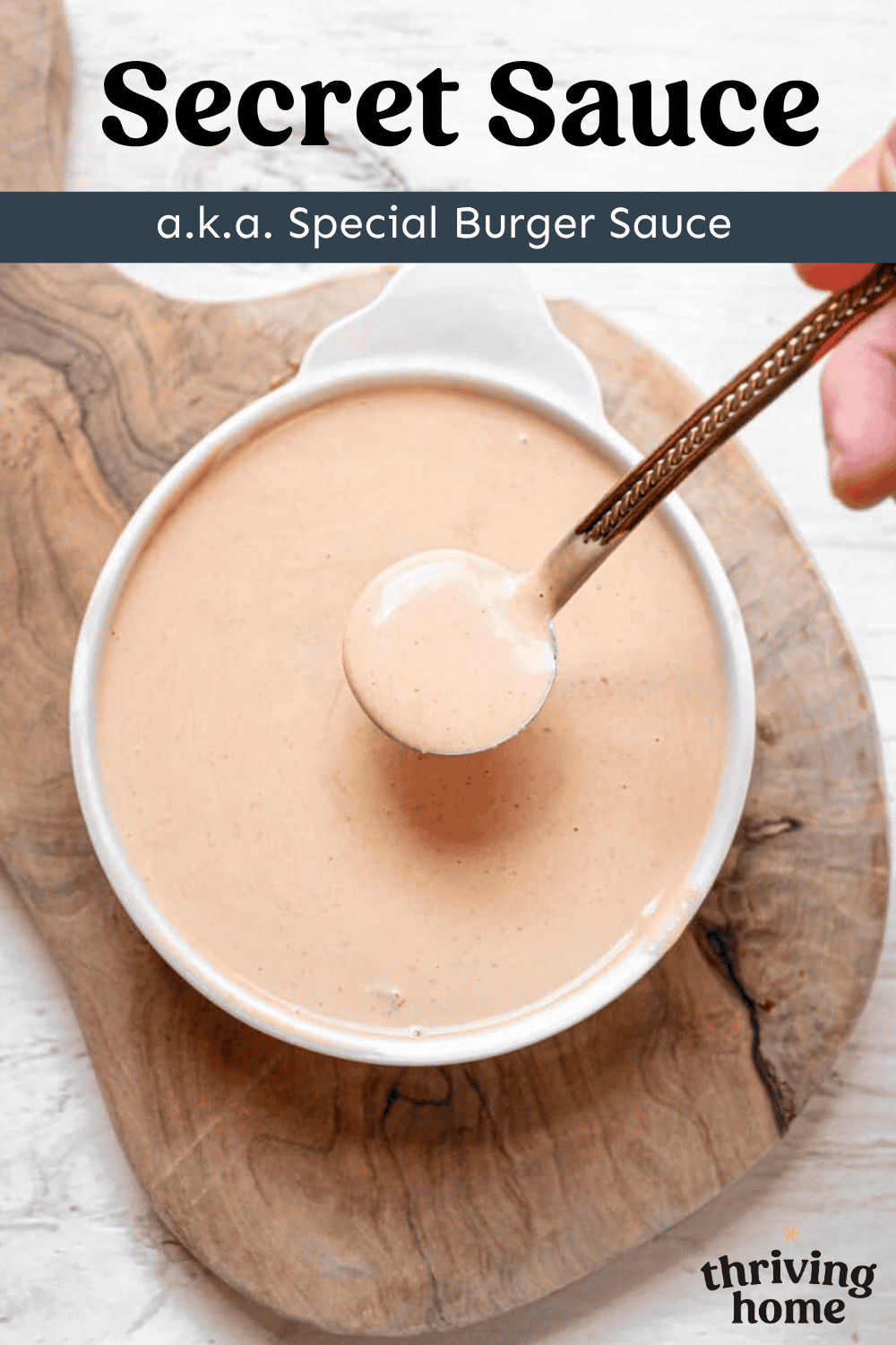Bowl of secret burger sauce with a small spoon to drizzle it on burgers.