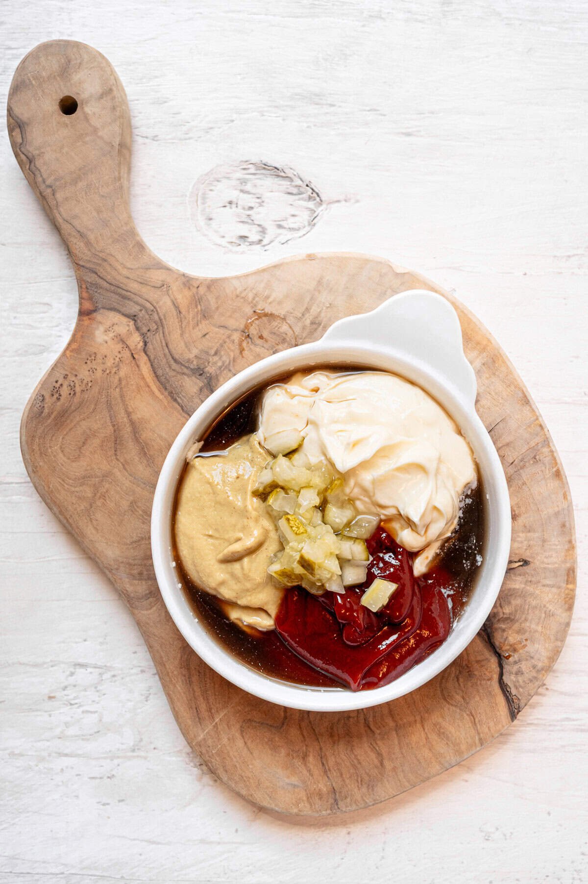 Cheeseburger egg roll secret sauce ingredients all in a small dish ready to be mixed together.