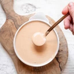 Thriving Home's secret sauce being spooned out of a small dish.