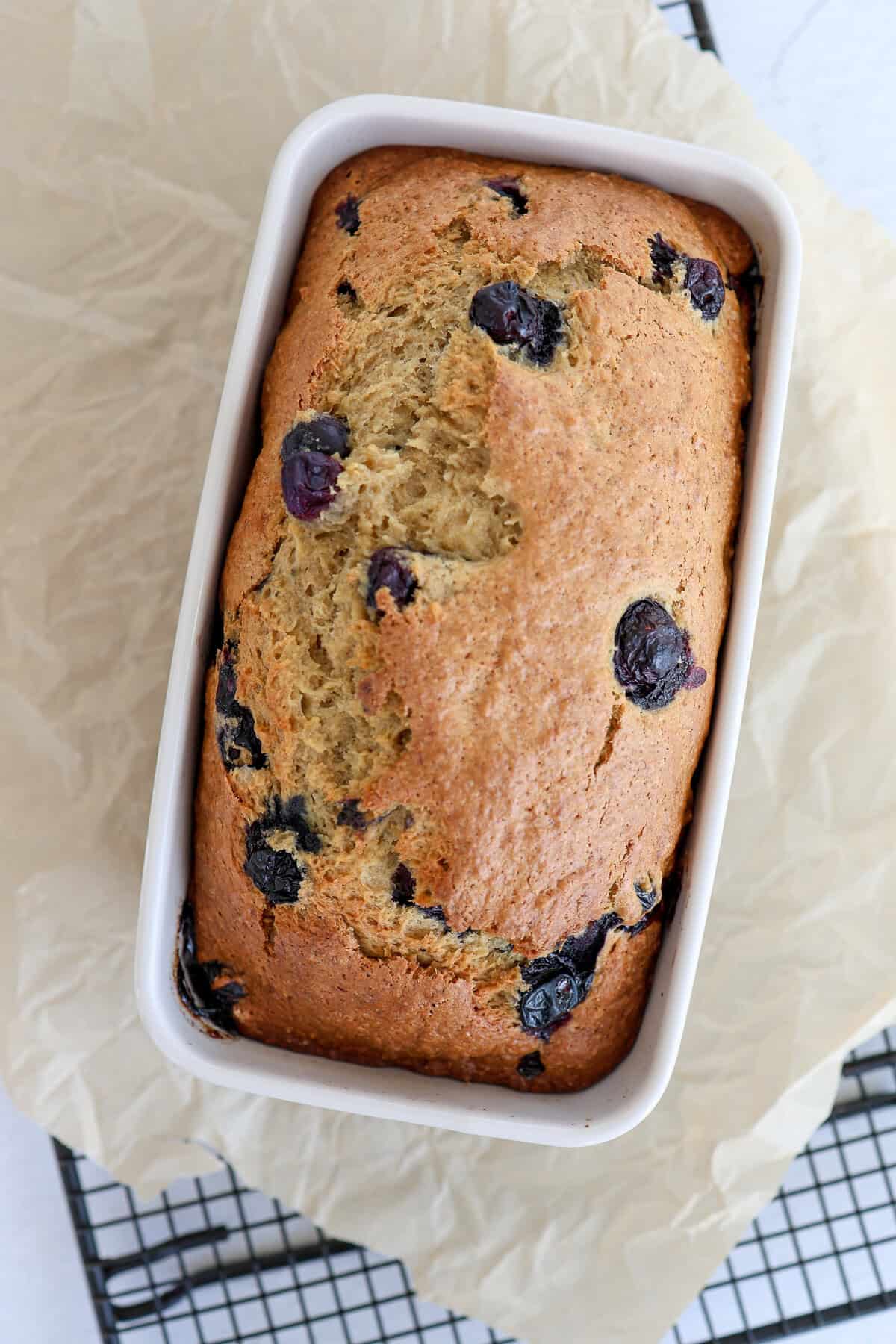 A loaf of blueberry banana bread straight from the oven (still in the pan).