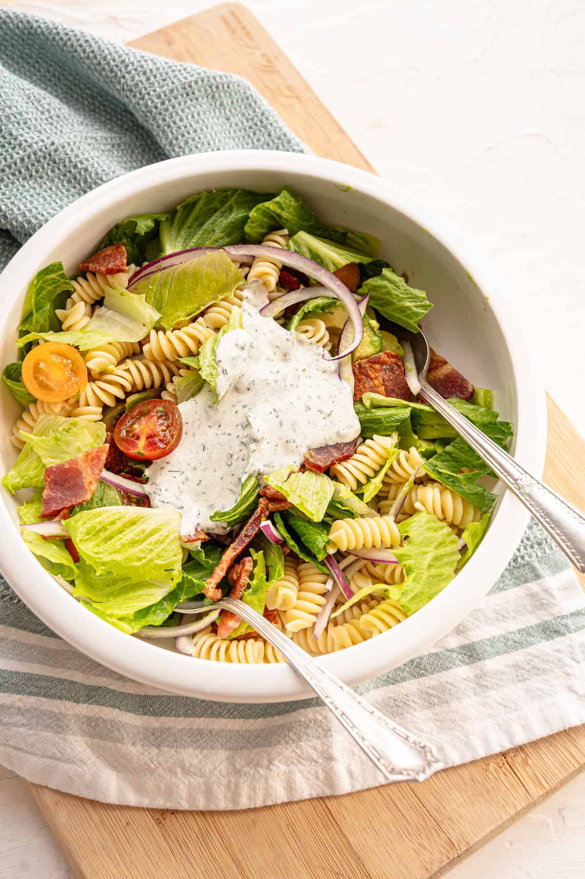 Salad ingredients in a bowl with a spoonful of homemade ranch dressing on top.