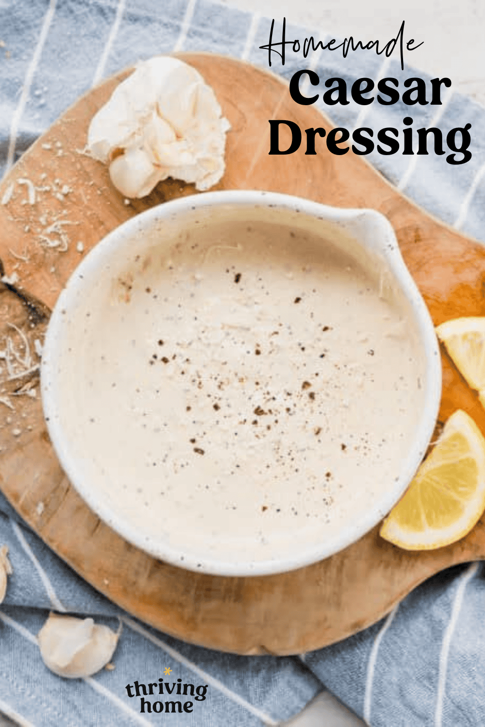 A bowl with pouring lip full of homemade Caesar dressing.