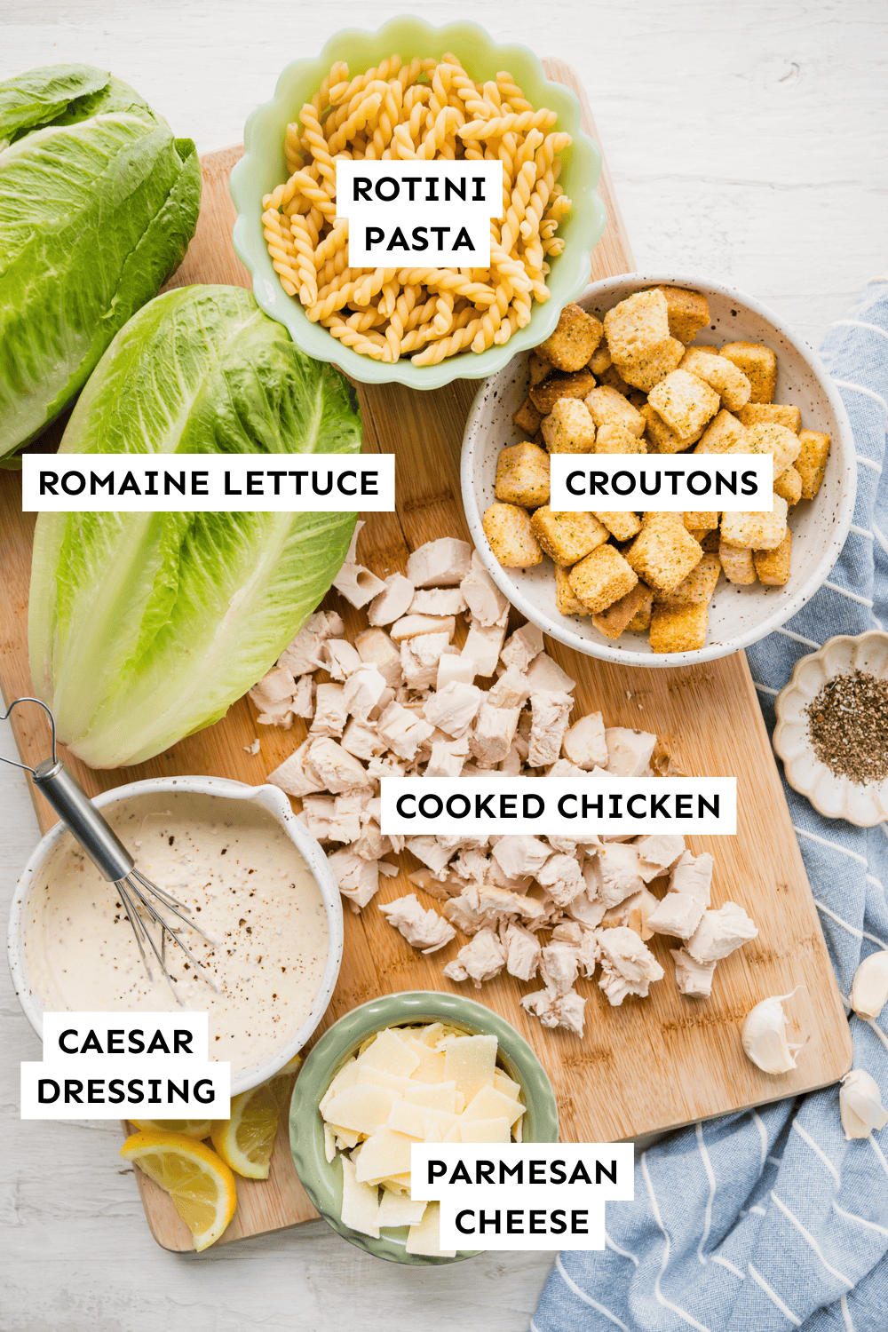 Ingredients for Caesar pasta salad with chicken measured out and labeled.