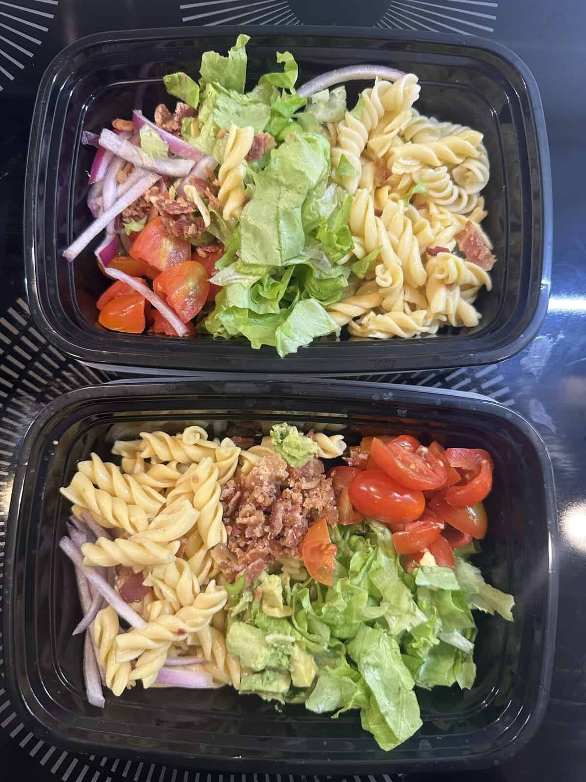 Two meal prep containers with BLT Pasta Salad components in them for the week ahead.
