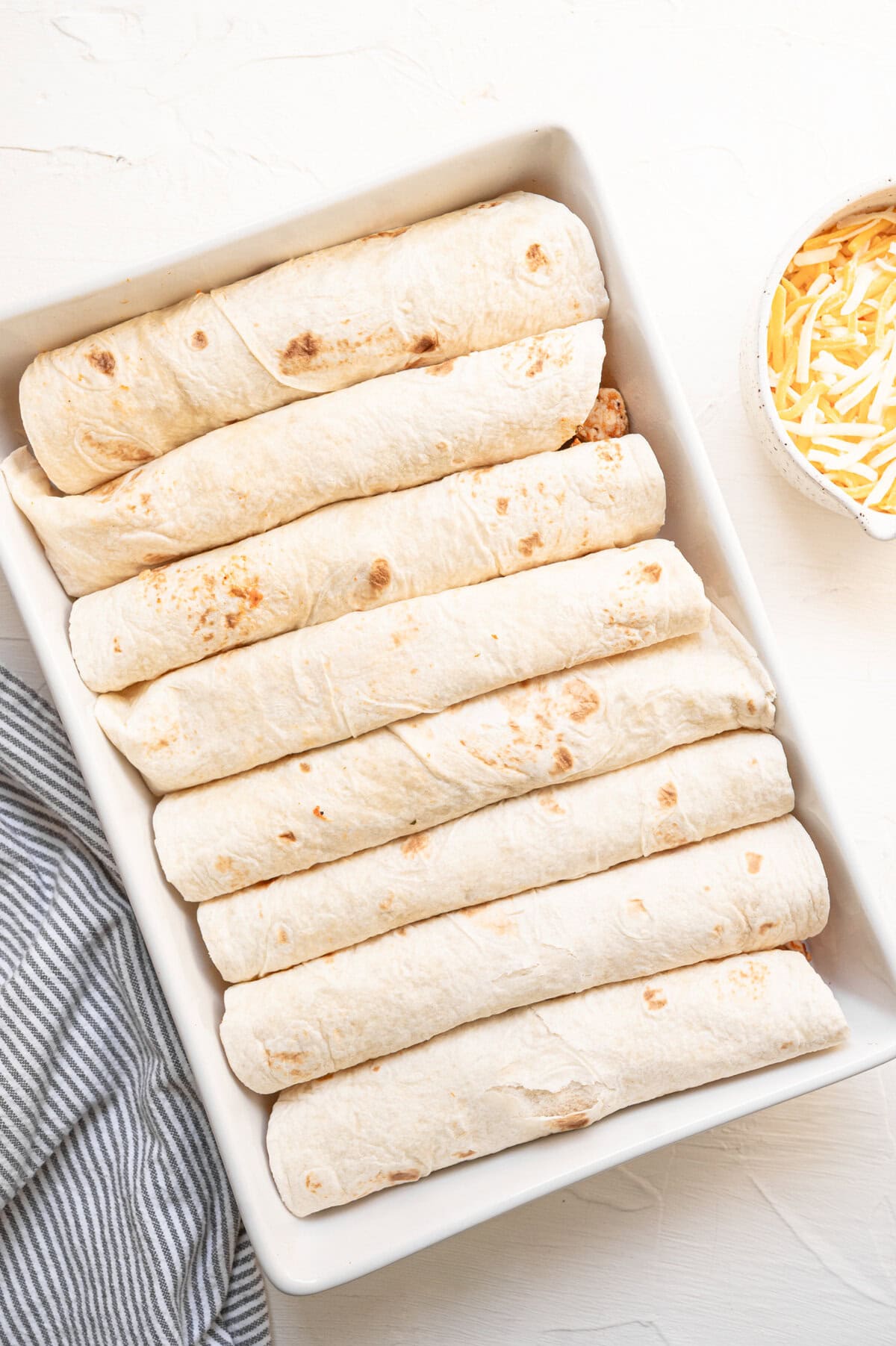 A dish full of prepped tortillas.