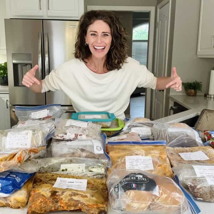 Rachel with a counter full of summer freezer meals.