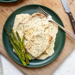 Mashed potatoes, grilled asparagus, sauteed pork chops all with Boursin gravy on top.